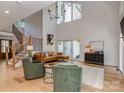 Open concept living room with two story window, wood floors and staircase at 202 Walden Ln, Weddington, NC 28104