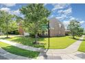Corner lot home featuring lush grass, mature trees, and neat sidewalks on a sunny day at 2100 Goddard Way, Waxhaw, NC 28173