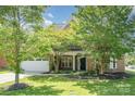 Charming brick home featuring a two-car garage and an inviting front entrance framed by lush greenery at 2100 Goddard Way, Waxhaw, NC 28173