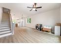 Spacious open-concept living room with hardwood floors, bright windows, and an adjoining staircase at 216 Mattoon St, Charlotte, NC 28216