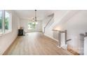 Inviting living room showcasing hardwood floors, stairs and natural light from large windows at 216 Mattoon St, Charlotte, NC 28216