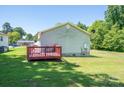 Exterior view of house highlighting a wooden deck on a grassy lawn at 219 E Boston Ave # 141516, Bessemer City, NC 28016