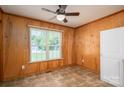 Bright dining area with wood paneled walls, tile flooring, and large window at 219 E Boston Ave # 141516, Bessemer City, NC 28016