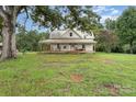Picturesque home with a large front yard and inviting porch, ideal for a peaceful countryside lifestyle at 220 Low Water Bridge Rd, Troy, NC 27371