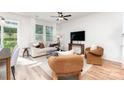 Inviting living room with abundant natural light, modern furnishings, and a ceiling fan at 2818 Old Steele Creek Rd, Charlotte, NC 28208