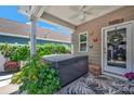 Relaxing covered porch with a hot tub, ceiling fan, and view of the lush backyard at 282 Harrison Ln, Locust, NC 28097