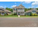 Inviting two-story home with a double porch, landscaped front yard, and a welcoming facade at 282 Harrison Ln, Locust, NC 28097