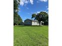 A sprawling green lawn surrounds a cozy home with a detached garage at 28518 Flint Ridge Rd, Albemarle, NC 28001