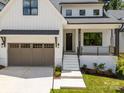 Charming two-story home with a white exterior, covered porch, and manicured lawn at 3949 Plainview Rd, Charlotte, NC 28208
