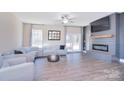 Comfortable living room with a modern fireplace, mounted television and plush seating at 4017 Avis Way, Monroe, NC 28110