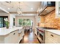 Gourmet kitchen boasts custom cabinets, a farmhouse sink, an oversized window and professional-grade appliances at 4023 Alexandra Alley Dr, Charlotte, NC 28210