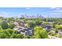 Scenic aerial view showcasing modern townhomes surrounded by lush greenery and the city skyline at 412 State St, Charlotte, NC 28208