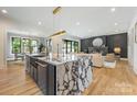 Open-concept kitchen with marble island, stainless appliances, and hardwood floors at 4900 Doris Ave, Charlotte, NC 28205