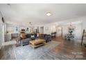 Open concept living room featuring a large sectional sofa, hardwood floors, and ample natural light at 5499 Angus Dr, Stanfield, NC 28163