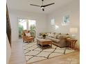 Cozy living room featuring hardwood floors, a plush sofa, a decorative rug, and a sliding glass door at 716 Drakeford Ct, Charlotte, NC 28216