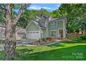 Charming two-story home with a well-manicured lawn and attached two-car garage at 807 Water Wheel Ct, Charlotte, NC 28209