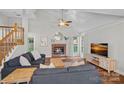 Bright living room with vaulted ceilings, brick fireplace, and hardwood floors at 807 Water Wheel Ct, Charlotte, NC 28209