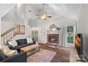 Bright living room with vaulted ceilings, brick fireplace, and access to the outdoor deck at 807 Water Wheel Ct, Charlotte, NC 28209