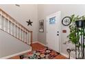 Inviting entryway with wood floors, white staircase and a charming Lake Norman compass rose decor at 103 Pamlico Ln, Mooresville, NC 28117