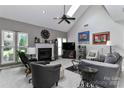Bright living room showcasing a cozy fireplace, modern furnishings, vaulted ceiling and skylight at 103 Pamlico Ln, Mooresville, NC 28117