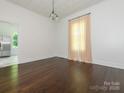 Bright dining room featuring wood floors, large window and a chandelier at 110 College St, Marshville, NC 28103