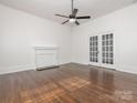 Bright living room with hardwood floors, a decorative fireplace, and French doors to another room at 110 College St, Marshville, NC 28103