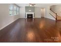 Open concept living room with hardwood floors, fireplace, and staircase at 1332 Kings Grove Dr # Lot 18, York, SC 29745