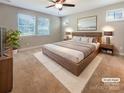 Bright main bedroom featuring a large bed, plush carpet, and modern decor at 1332 Kings Grove Dr # Lot 18, York, SC 29745