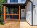 Charming front porch with black railings, natural wood posts, and the house number displayed prominently at 135 Brookview Dr, Shelby, NC 28152