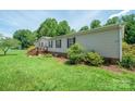 Traditional home featuring lush trees and inviting front porch with stairs at 1495 Leonards Fork Church Rd, Lincolnton, NC 28092