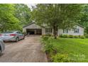 This exterior view showcases a well-maintained home with an attached garage and a neatly manicured front lawn at 1713 Poe Cir, Hickory, NC 28601
