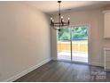 Dining room features a modern chandelier and sliding door access to the outdoor deck at 2051 Highwood Rd, Rock Hill, SC 29732
