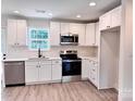 Modern kitchen with stainless steel appliances, white cabinets, and quartz countertops at 2063 Highwood Rd, Rock Hill, SC 29732