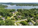 Aerial view of a neighborhood with houses, lush trees, and a glimpse of a lake in the background at 2074 Brandt Rd, York, SC 29745