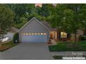 Charming home with a two-car garage, brick facade, manicured lawn, and inviting curb appeal at 210 Oak Village Pkwy, Mooresville, NC 28117