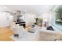 Bright, open-concept living space with hardwood floors and stylish modern furnishings at 2120 Shadyview Dr, Charlotte, NC 28210