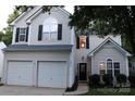 Traditional home with a two-car garage, black door, and manicured front yard at 3092 S Legacy Park Blvd, Fort Mill, SC 29707
