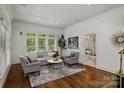 Bright living room with large windows, hardwood floors, and stylish neutral furnishings at 3408 Sandalwood Ln, Waxhaw, NC 28173