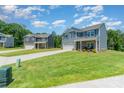 View of multiple two-story homes featuring stone accents, attached two-car garages, and large lawns at 3654 Azalea Ridge Dr, Mount Holly, NC 28102