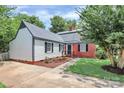 A lovely, well-maintained home with white siding, red brick, and a neatly manicured lawn at 3909 Woodbriar Trl, Charlotte, NC 28205