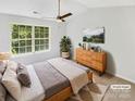 Serene main bedroom features a large window, ceiling fan, and stylish decor at 5163 Ficus Tree Ln, Charlotte, NC 28215