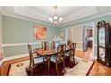 Elegant dining room with wood floors, chandelier, and views to the kitchen at 6309 Chamar Cir, Kannapolis, NC 28081