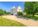 Exterior view of a two-story home with a concrete driveway and well-maintained lawn at 7737 Pleasant Valley Dr, Harrisburg, NC 28075