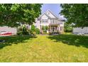 A spacious front yard with lush green grass and a charming two-story home in the background at 7737 Pleasant Valley Dr, Harrisburg, NC 28075