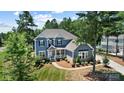 Lovely two-story home with a welcoming front porch, well-maintained lawn, and mature trees in the yard at 101 Cross Current Ln, Belmont, NC 28012