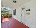 Welcoming front porch with white door and classic details, perfect for enjoying peaceful moments outdoors at 1113 W 4Th Ave, Gastonia, NC 28052