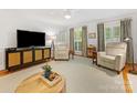 Cozy living room with stylish furnishings, a large TV, and neutral color scheme at 1119 Holleybank Dr, Matthews, NC 28105