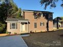 This two-story home features dark siding, black shutters, and a well manicured lawn at 112 Gilliatt St # 1, Shelby, NC 28150