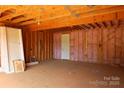 Spacious unfinished garage with exposed ceiling structure, ready for personalization and storage solutions at 114 Still Creek Dr, Mooresville, NC 28115
