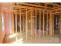 Framed interior of the house shows the structural layout with pink insulation and electrical wiring ready for finishing at 114 Still Creek Dr, Mooresville, NC 28115